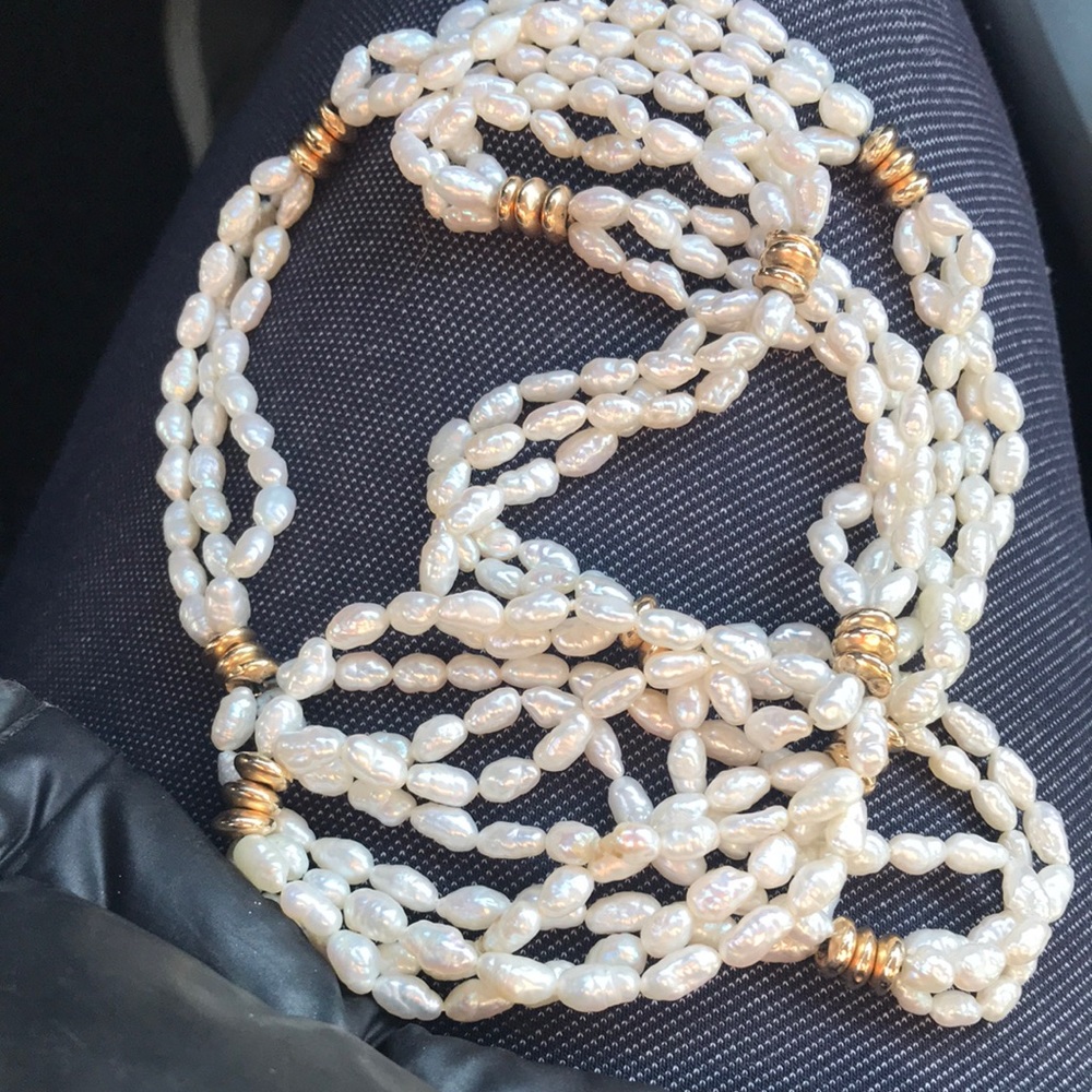 Beautiful fresh water pearl necklace with gold charm every three inches